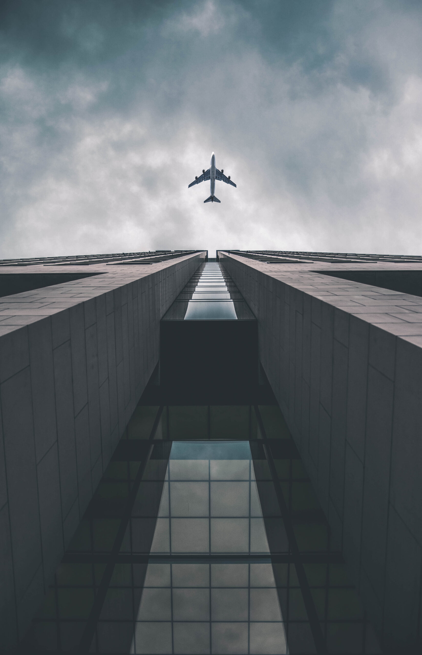 Low,Angle,View,Of,Modern,Tall,Business,Building.,Commercial,Jet